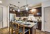 Modern kitchen with dark wood cabinets and a stylish island setup.