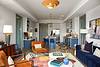 A stylish living space featuring modern decor, vibrant colors, and an open kitchen.