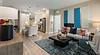 A modern living room and kitchen with stylish decor and neutral tones.