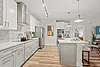 Modern kitchen featuring stainless steel appliances and a sleek design.