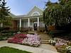 Beautiful home with a welcoming front entrance and vibrant flower beds.