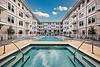 Swimming pool with seating and view of apartment building