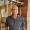 man with glasses and polo shirt