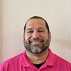man wearing pink shirt and black undershirt