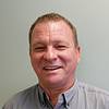 smiling man in button-up shirt