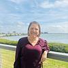smiling woman leaning against railing