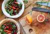 plates of salad with berries, citrus, and greens