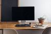 desk with computer, notebooks, and plant