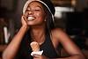 woman smiling and holding ice cream cone