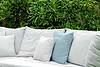 Outdoor couch with greenery in background