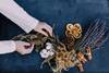 hands arranging dried herbs