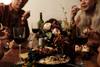 people gathered around table with wine glasses
