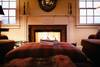 living area with fireplace and large ottoman
