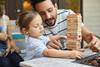 father and child playing Jenga