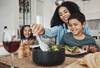 mom with kids at table serving food