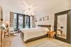 Bedroom with bed, desk, chair, and mirror