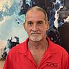 Man with grey hair wearing red shirt