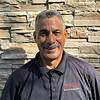 smiling man with mustache and polo shirt
