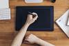 Person writing on tablet