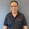 smiling man with polo shirt and glasses