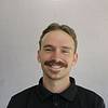 Man with red shirt and mustache