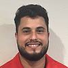 man smiling wearing red shirt