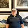 man wearing polo shirt and baseball cap