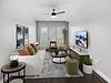 Modern living room with stylish furniture and large windows.