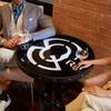 people sitting at small table with drinks