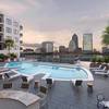 Swimming pool with seating and view of city skyline