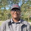 smiling man with glasses and baseball cap