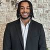 man with dreads wearing suit jacket