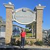 person standing in front of property sign