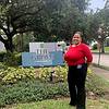 woman smiling near property sign