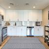 Kitchen with stainless steel appliances and white cabinetry.