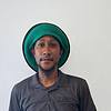 man wearing gray shirt and green hat