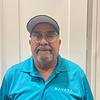 man smiling with blue shirt and hat