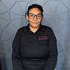 woman with glasses and dark polo shirt