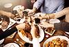 People toasting glasses around table
