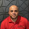 man with short beard and polo shirt