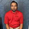 man with short hair wearing red polo shirt