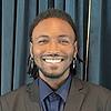 smiling man wearing earrings