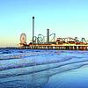boardwalk amusement park seen from beach