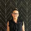 smiling woman with glasses and hair in bun