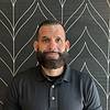 man with beard and short hair in polo shirt