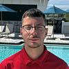 man with glasses and red shirt