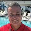 Man smiling next to pool