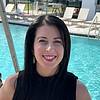 Woman smiling next to pool