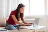 woman on couch with laptop