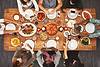 People gathered around table with food